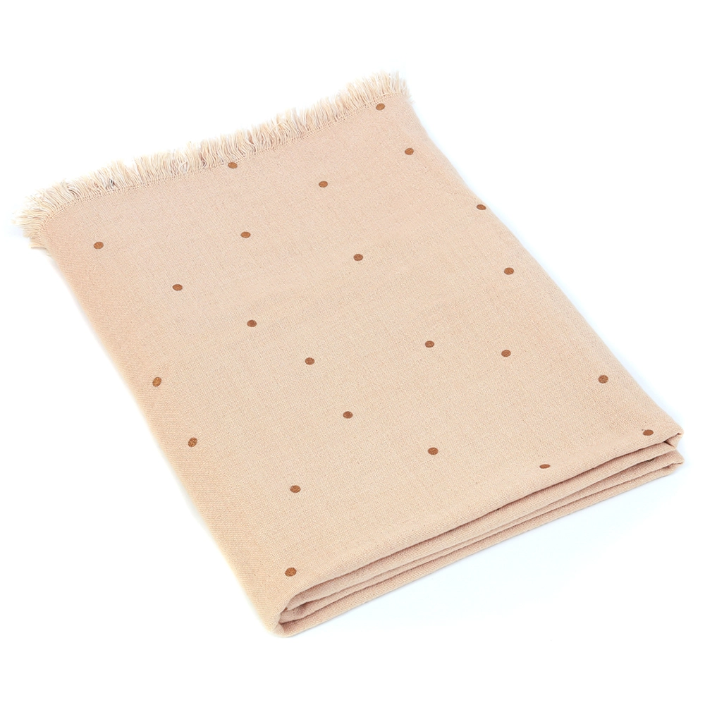 Tissu beige clair à pois, capturé en studio pour Mondial Tissu.